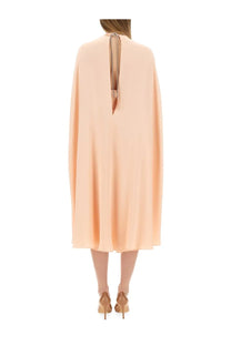 Max mara women’s flowing peach-colored cape dress with back tie detail shown from the back