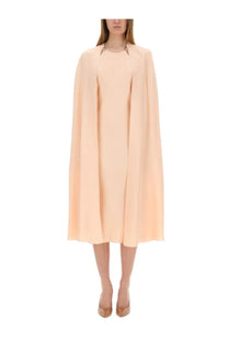 Max mara women’s flowing cape dress in soft peach with sleek minimalist design and subtle metallic neckline accents