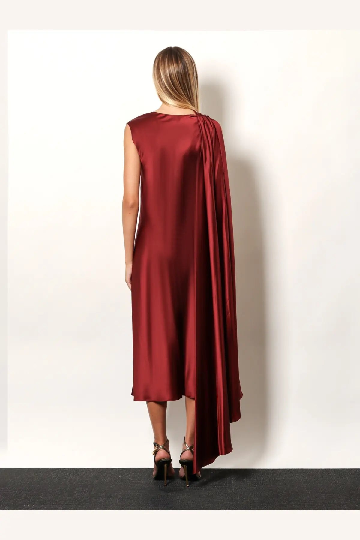 Max Mara women’s Edolo silk dress in red with a sleek burgundy satin finish and draped asymmetrical capelet detail