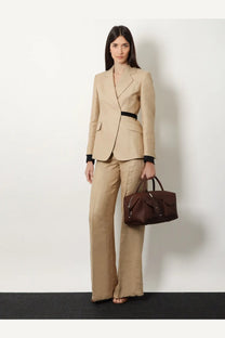 Beige tailored blazer with black belt and matching wide-leg trousers styled with max mara brown leather holdall handbag