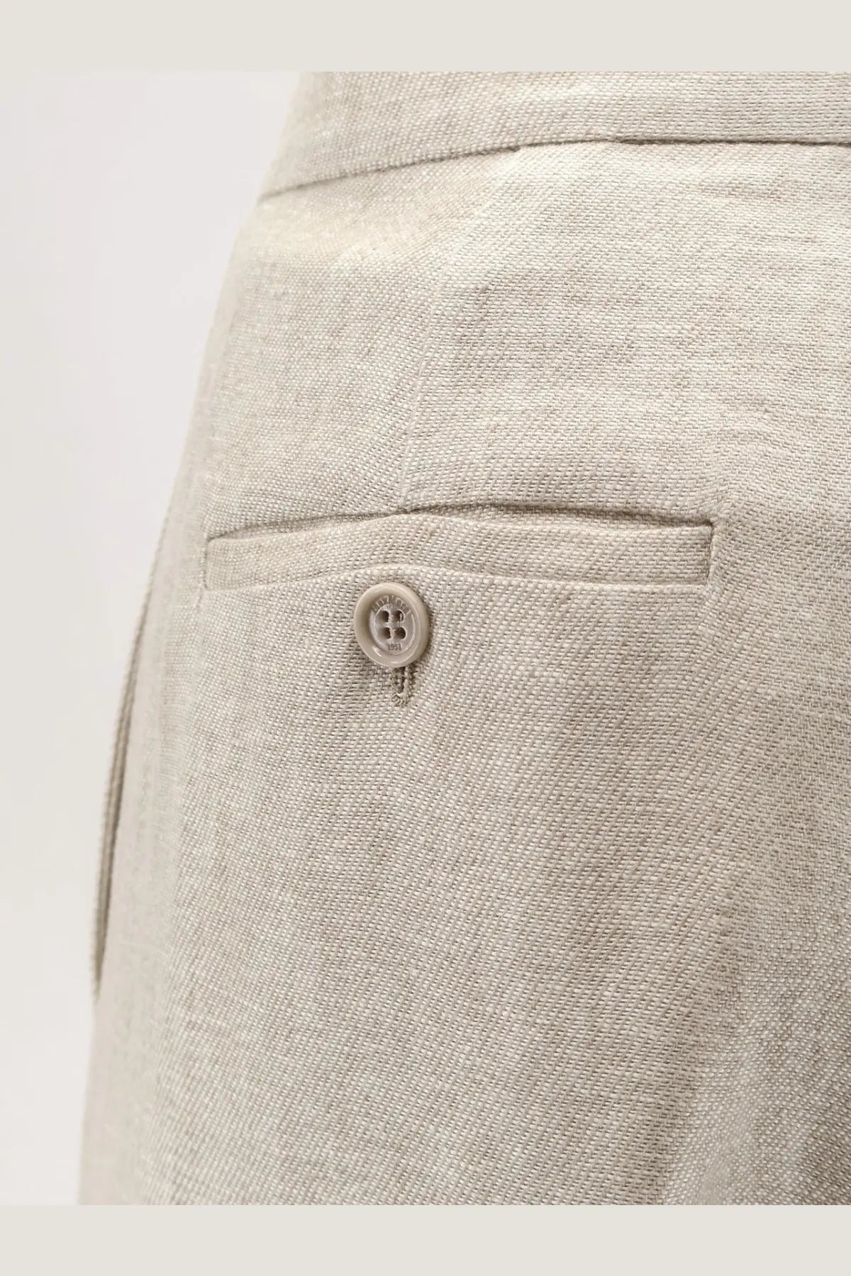 Beige linen ginnico trousers by max mara showing the back with subtle woven texture and single button pocket closure