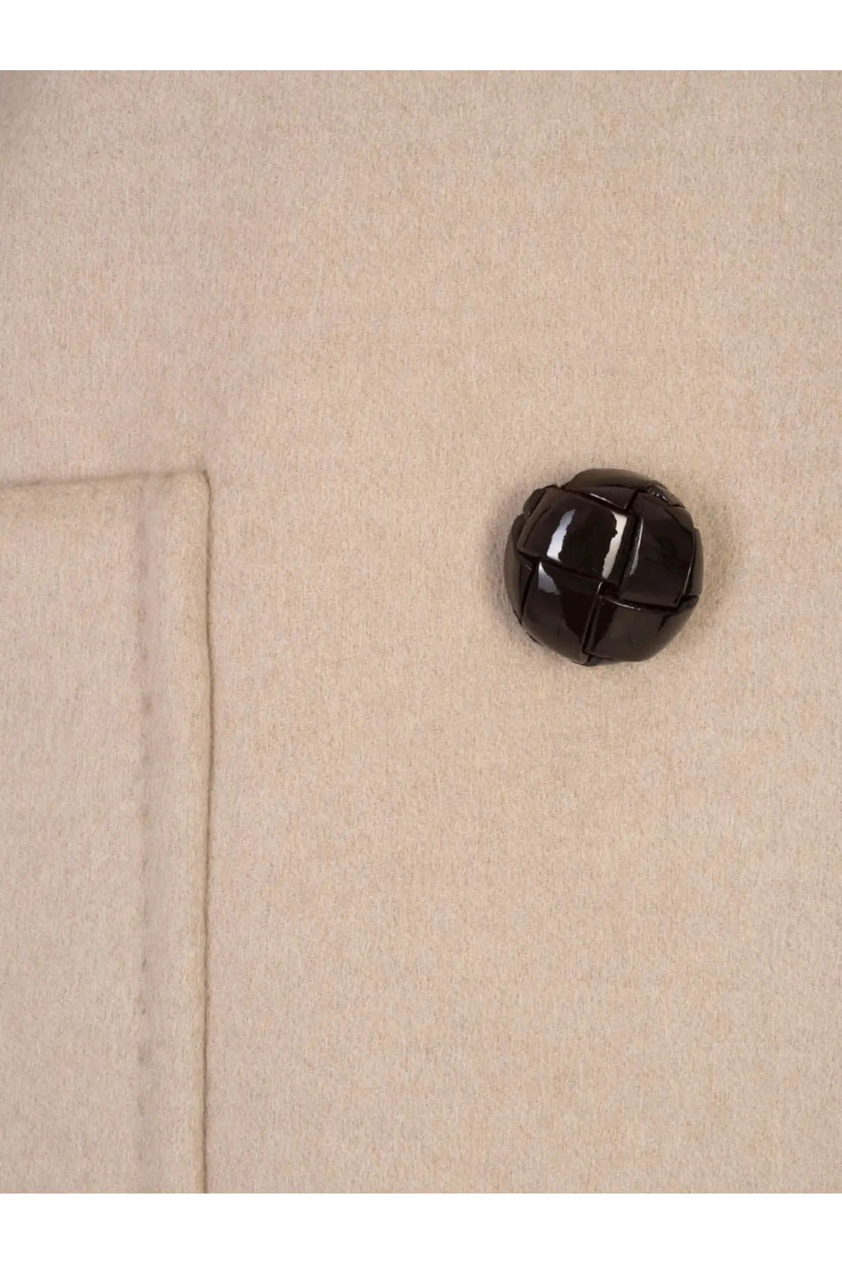 A glossy black quilted button on the beige cashmere fabric of the Max Mara womens Mario double breasted coat