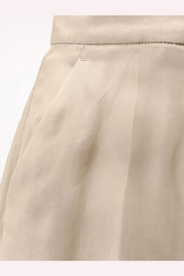 Max Mara women’s mxeolivi beige silk trousers with a pleated skirt design and subtle stitching along the waistband