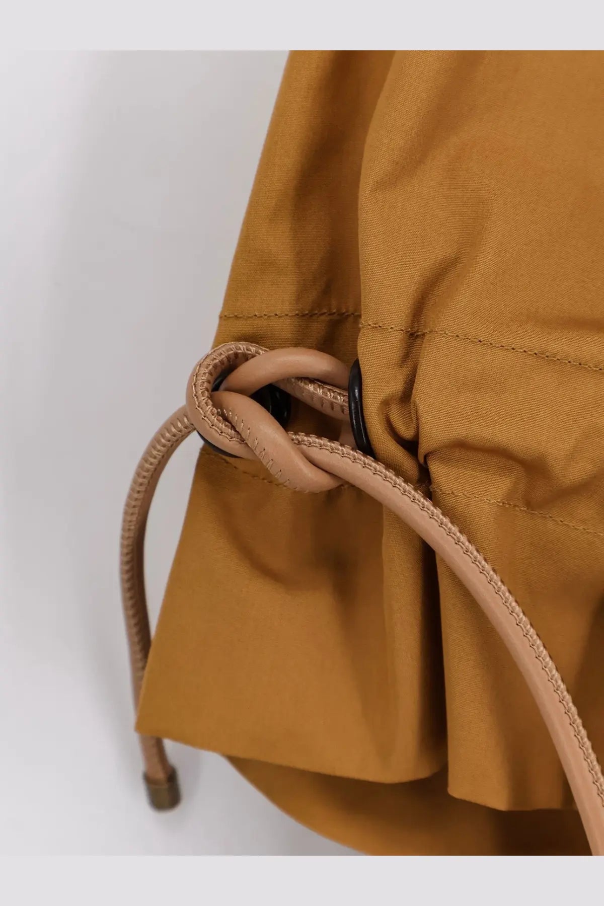 Tan woven drawstring tied in a knot on mustard yellow fabric bag of max mara women’s mxmadorni cotton shirt terra