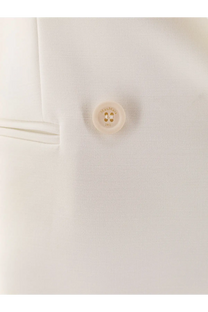A cream-colored circular button with hermès logo and 1951 engraving on max mara white virgin wool blazer