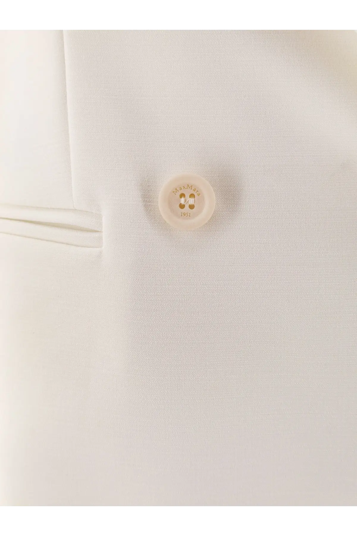 A cream-colored hermès button with 1951 engraving on the max mara white stretch virgin wool blazer