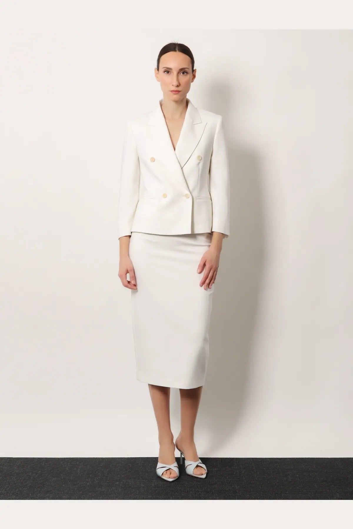 A sleek white double-breasted Max Mara women’s blazer with gold buttons made from stretch virgin wool