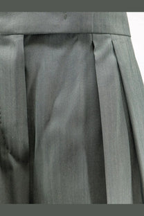 Gray pleated skirt with tailored waistband made of smooth structured fabric paired with max mara green trousers