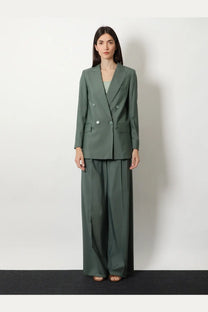 A sleek olive green double breasted blazer with silver buttons and structured shoulders paired with max mara trousers
