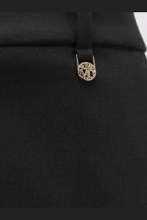 Black max mara women’s virgin wool trousers with a black fabric bag featuring a gold-tone metal clasp embossed logo