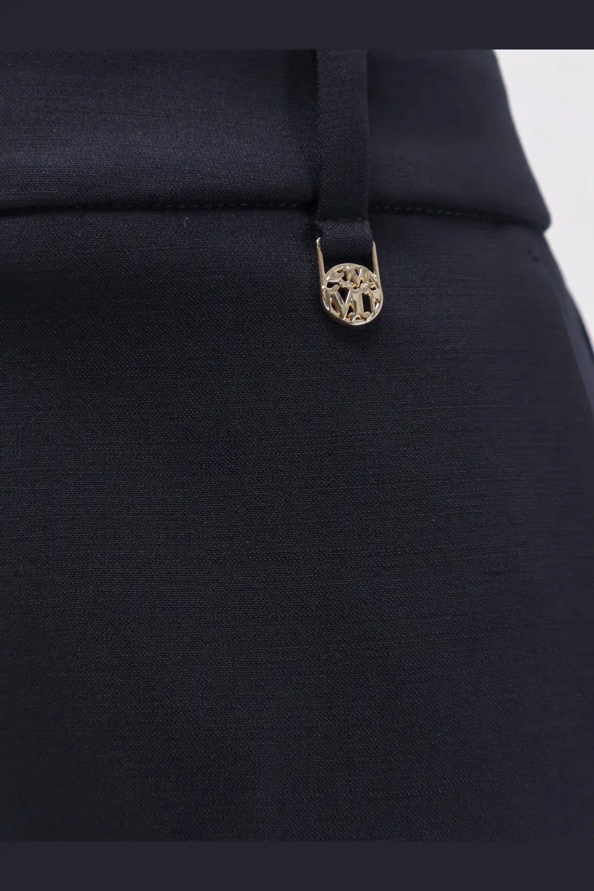 Black satin trousers with a gold-toned circular metal button featuring an intricate cut-out design by max mara