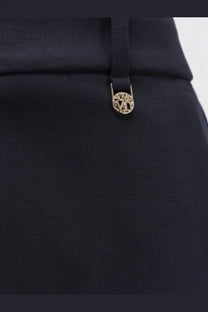 Black satin trousers with a gold-toned circular metal button featuring an intricate cut-out design by max mara