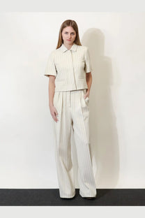A woman wearing max mara womens mxmosso cotton off-white pinstripe trousers with matching short-sleeved jacket