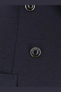 Black circular button with silver metallic rim on textured navy virgin wool fabric of max mara mxmricetta blazer