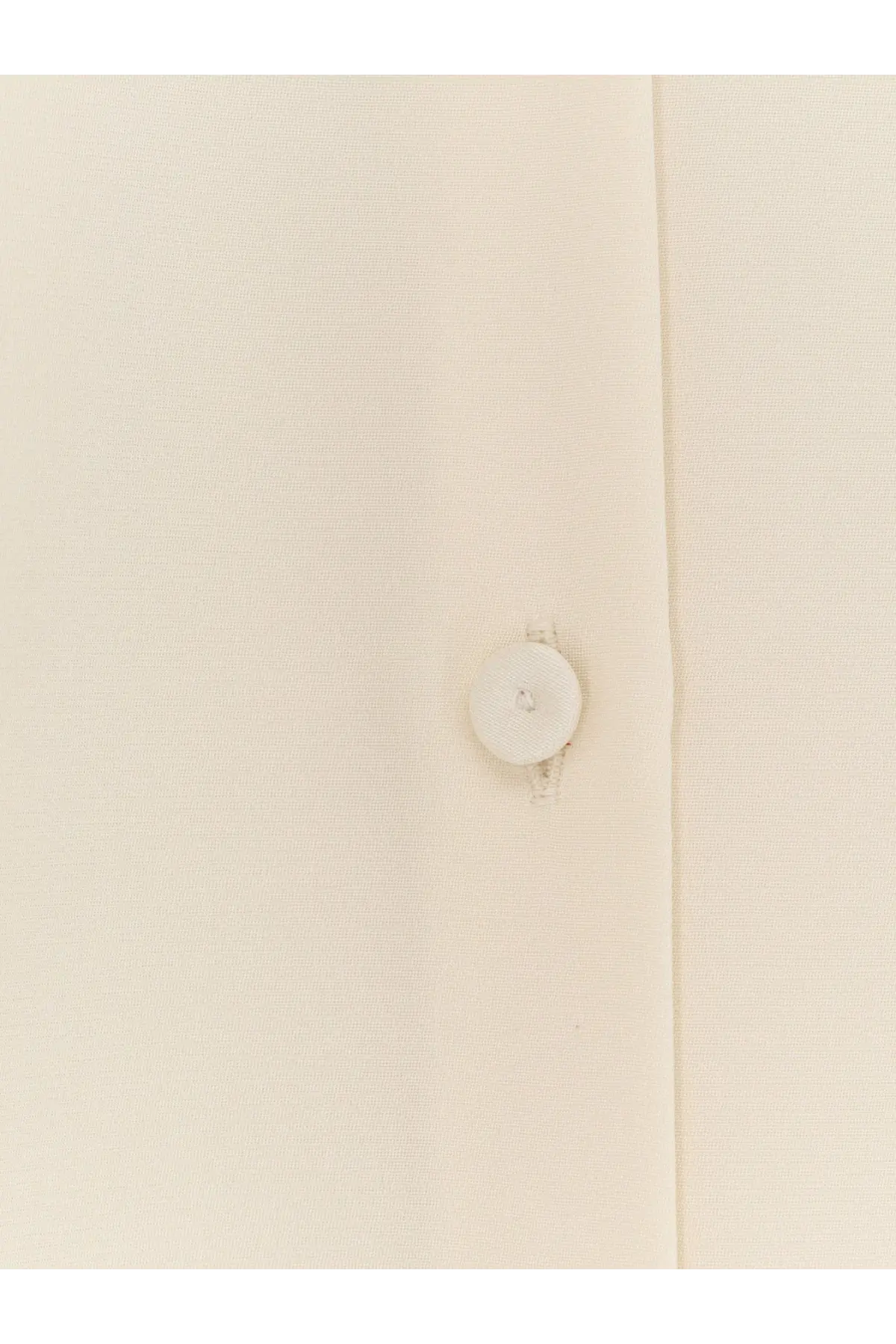 A crisp white button centered on the seam of a max mara womens mxpvoliera stretch silk white dress shirt