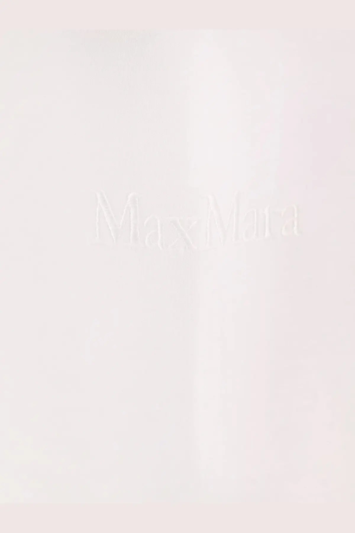 Minimalist white Max Mara logo embossed on smooth matte surface of Max Mara women’s Nerina cotton shirt white