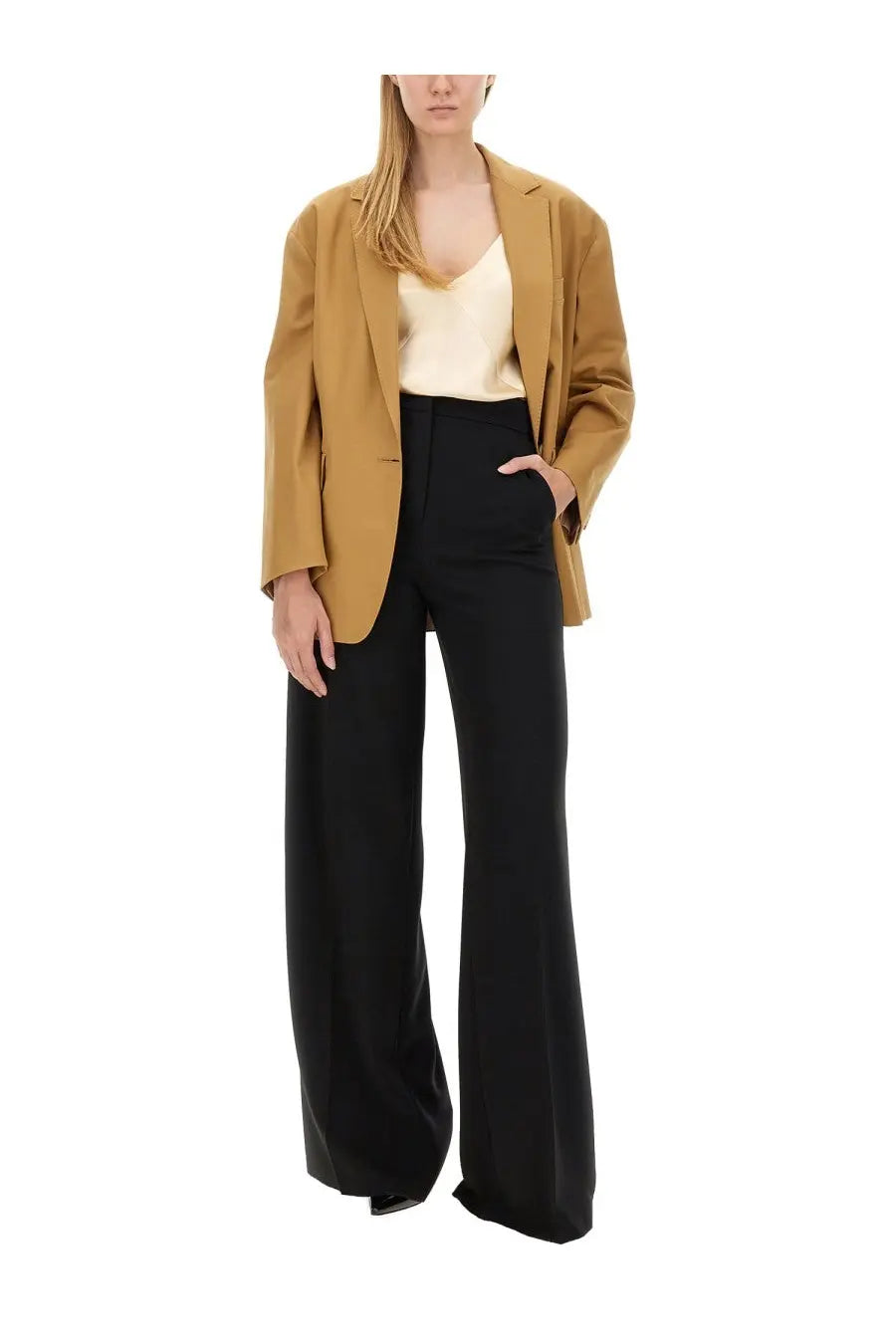A woman wears max mara women’s piano holm oak black high-waisted pants paired with a structured camel blazer