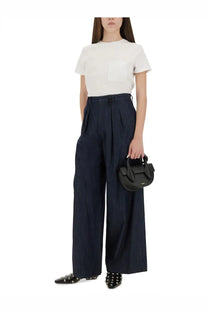 Black structured mini handbag with top handles and minimalist design paired with max mara women’s papaya shirt white