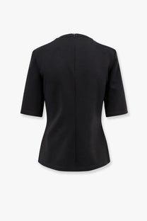 Max mara women’s peter wool black short-sleeved blouse with tailored fit shown from the back with central zipper