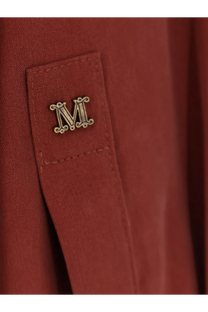 A gold-toned ornate m emblem pin on the rust-colored silk pocket of max mara womens siamese silk shirt brown