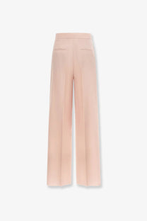 A pair of max mara women’s high-waisted silk and mohair trousers in beige with wide legs and subtle back pockets shown from the back