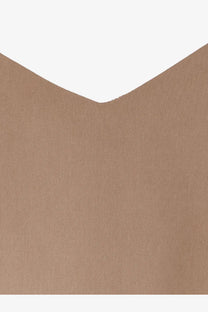 A close-up of tan silk textured fabric with a subtle weave pattern from max mara womens silk munghia top beige