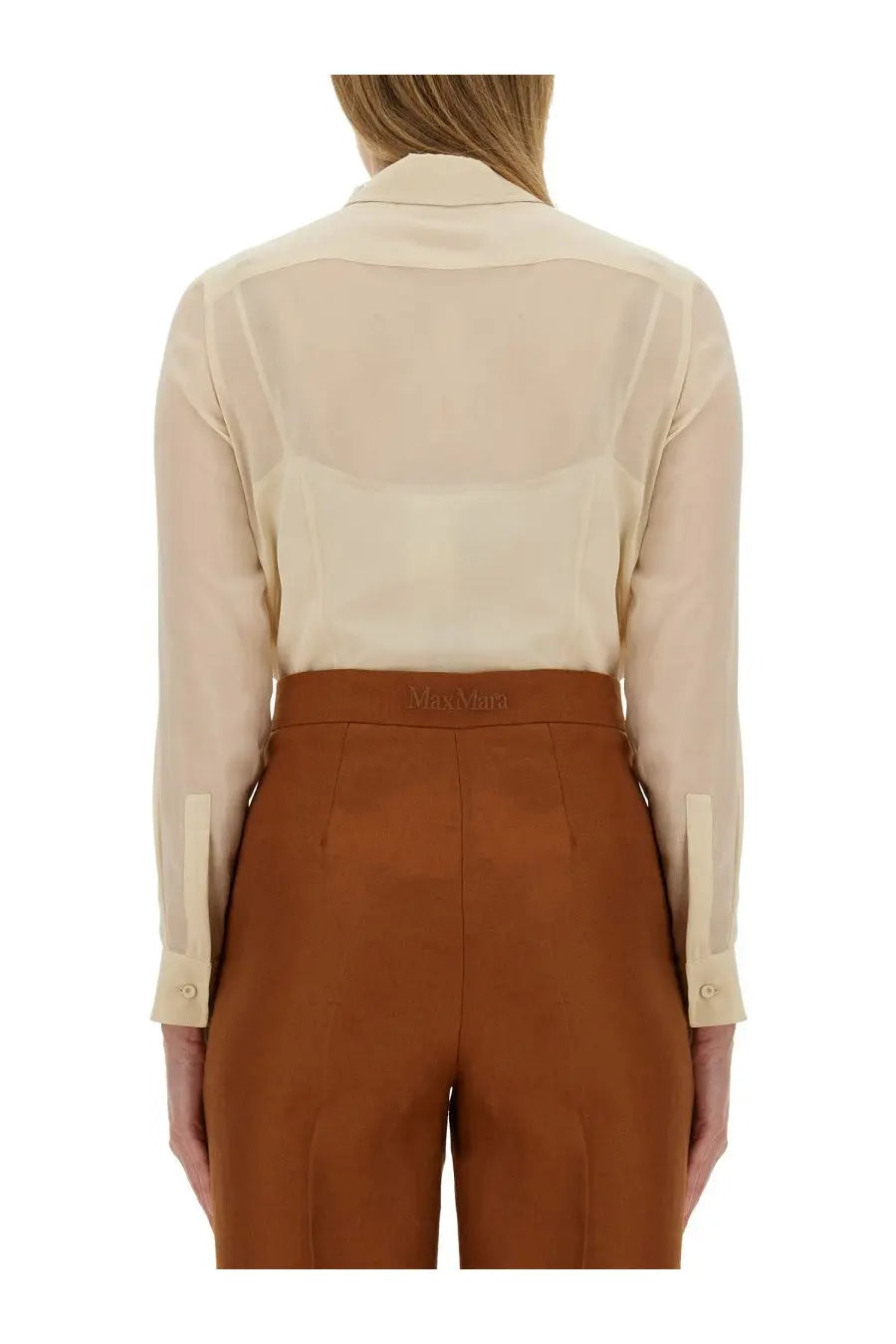 A beige semi-sheer silk blouse with classic collar and buttoned cuffs paired with brown high-waisted trousers