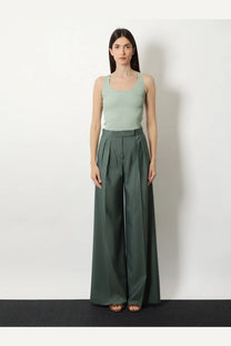 A pair of wide-leg high-waisted trousers in deep olive green viscose blend fabric with waist pleats