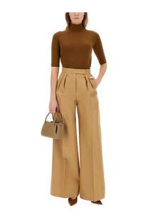 Tan leather mini handbag with top handle and front flap closure paired with max mara women’s beige wide leg pants