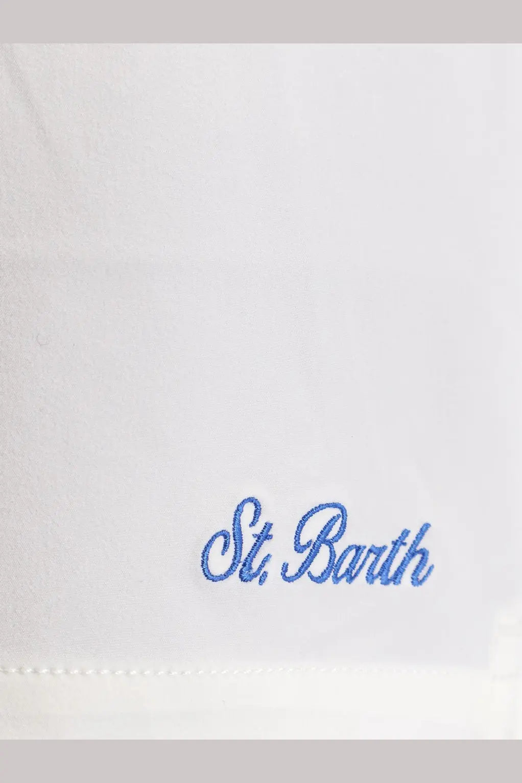 White fabric with blue embroidered st on the back of mc2 saint barth men’s comfort recycled nylon black swim boxer shorts