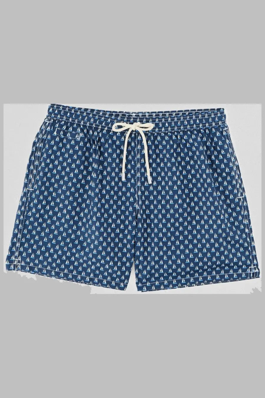 Navy blue Mc2 Saint Barth men’s swim trunks with white sailboat pattern and cream drawstrings for beachwear