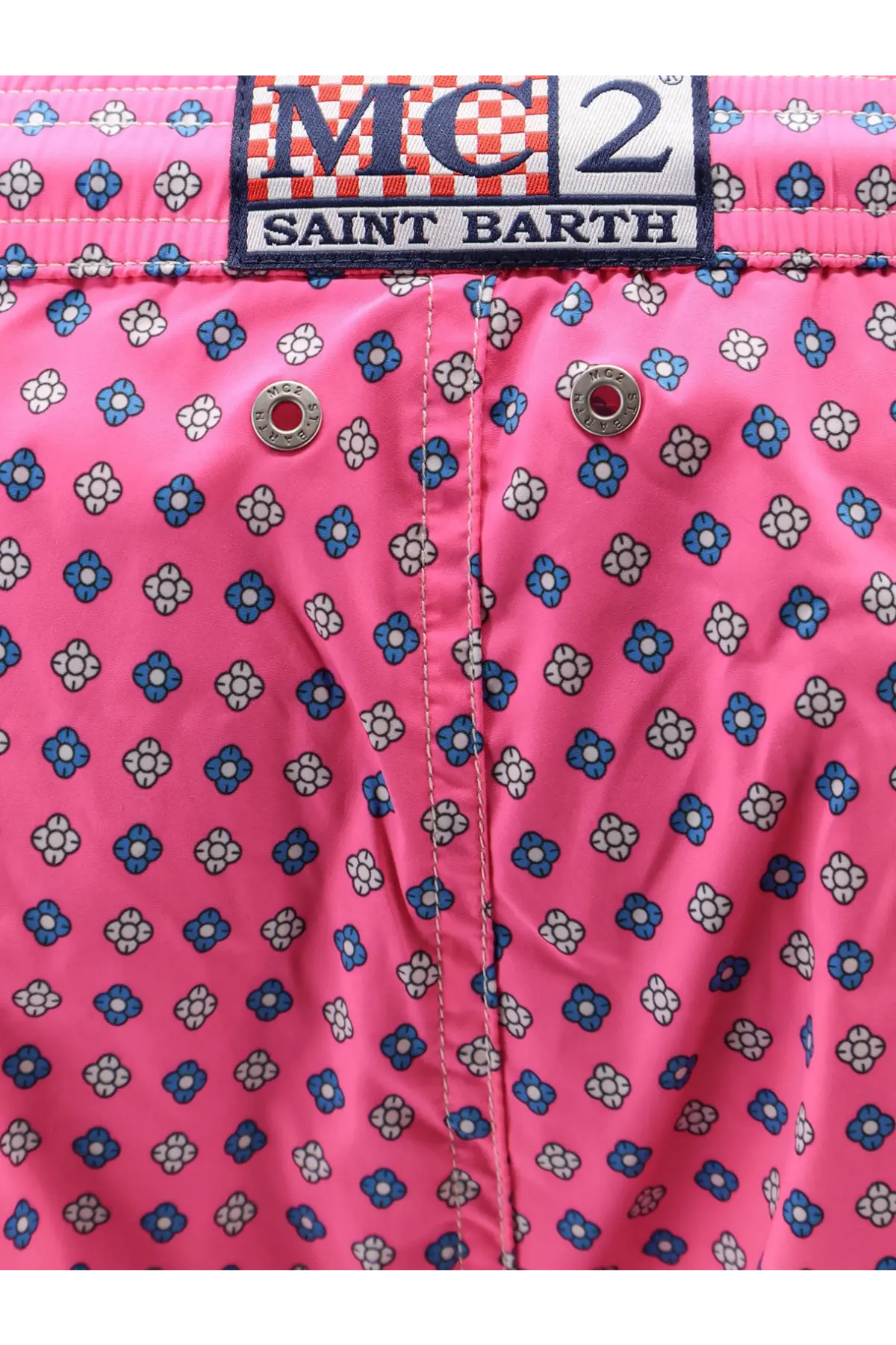 Bright pink nylon swim shorts with blue and white floral pattern and mc2 saint barth branded waistband label