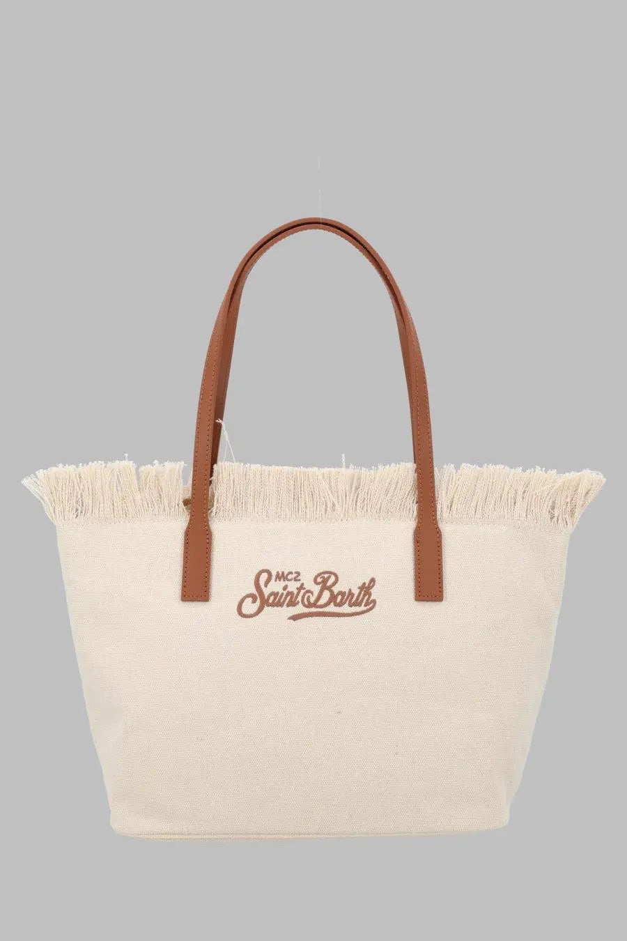 Cream-colored canvas tote bag with brown leather handles and embroidered mc2 saint barth logo in matching brown thread