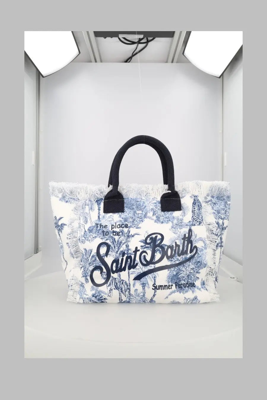 White canvas tote bag with blue tropical print black handles and saint barth branding mc2 saint barth women’s borsa vanity medium