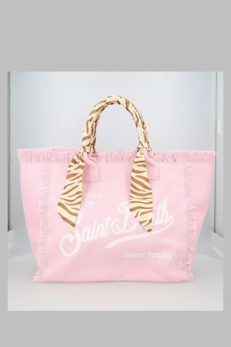 Mc2 saint barth women’s pink canvas tote bag with frayed edges white saint barth summer paradise lettering and zebra-print handles tied in a bow