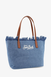 Blue denim shoulder tote bag with brown leather handles and white embroidered since saint barth logo by mc2 saint barth