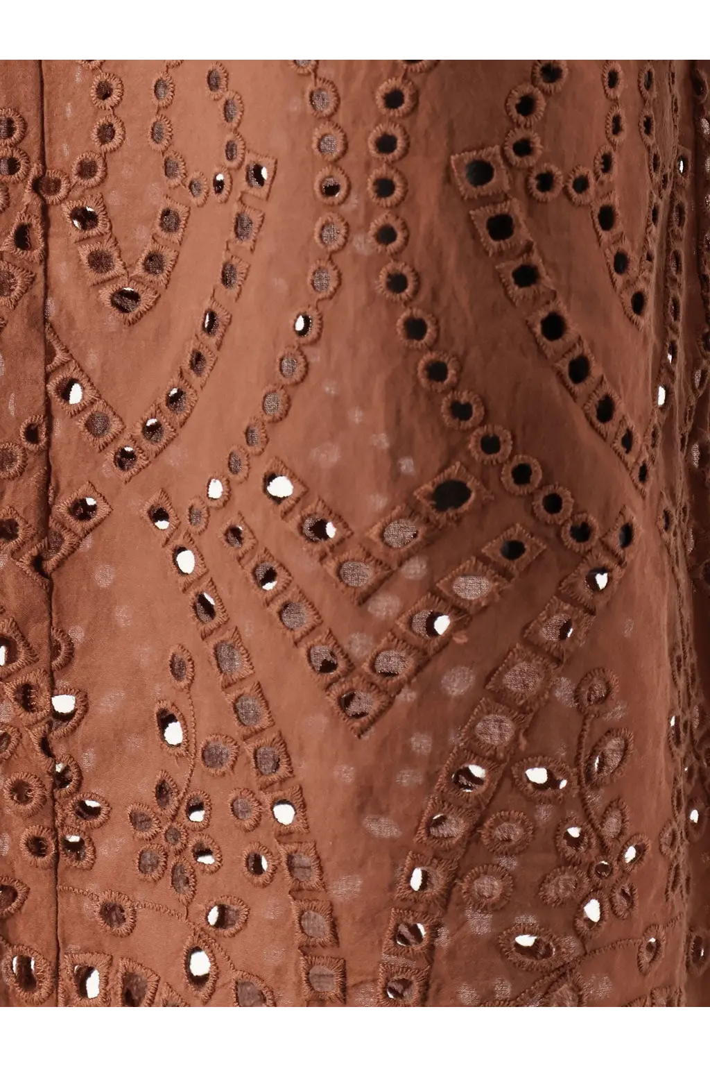 A rust-colored mc2 saint barth women’s inez sangallo lace trousers featuring intricate eyelet embroidery with geometric and floral patterns