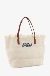 Beige canvas tote bag with brown leather handles and frayed top edge embroidered m.c by Mc2 Saint Barth