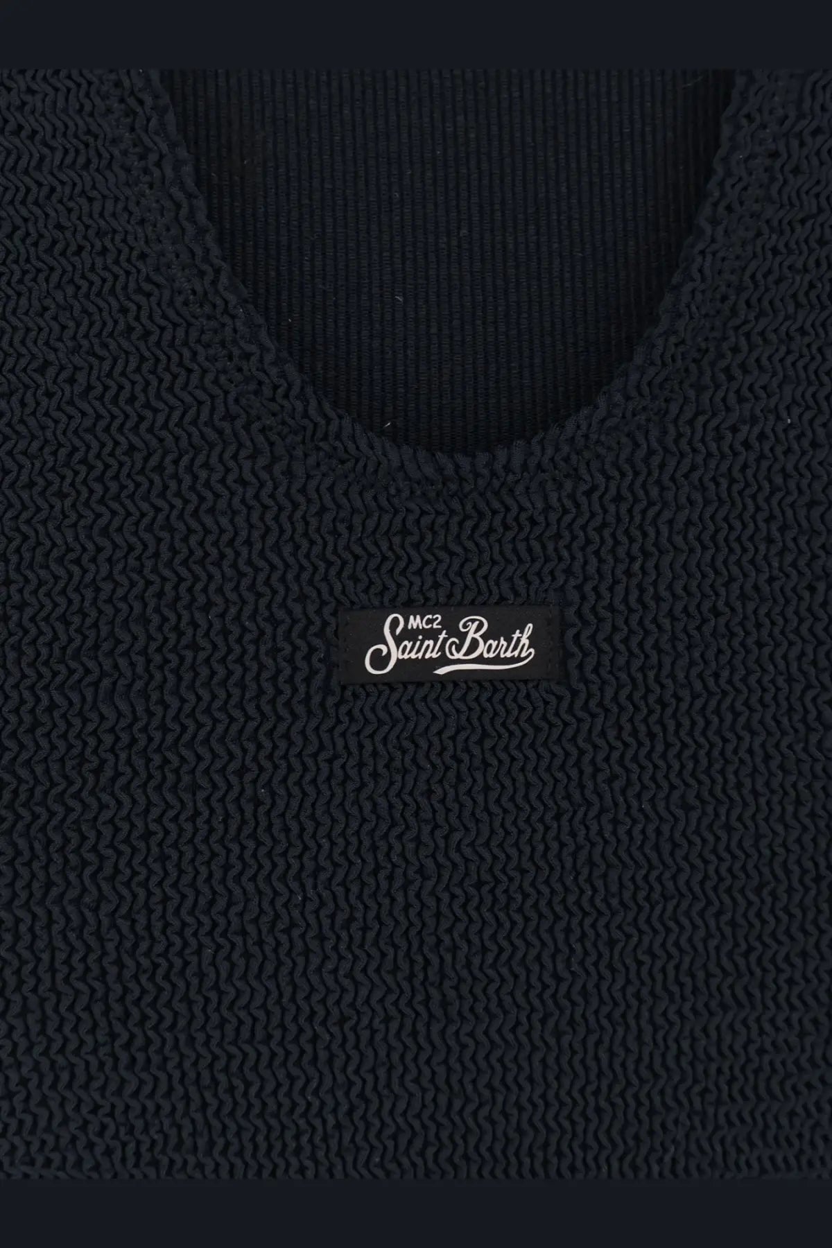 Black knitted tank top with ribbed texture and mc2 saint barth label paired with blue one piece swimsuit