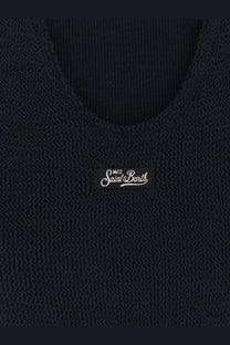 Black knitted tank top with ribbed texture and mc2 saint barth label paired with blue one piece swimsuit