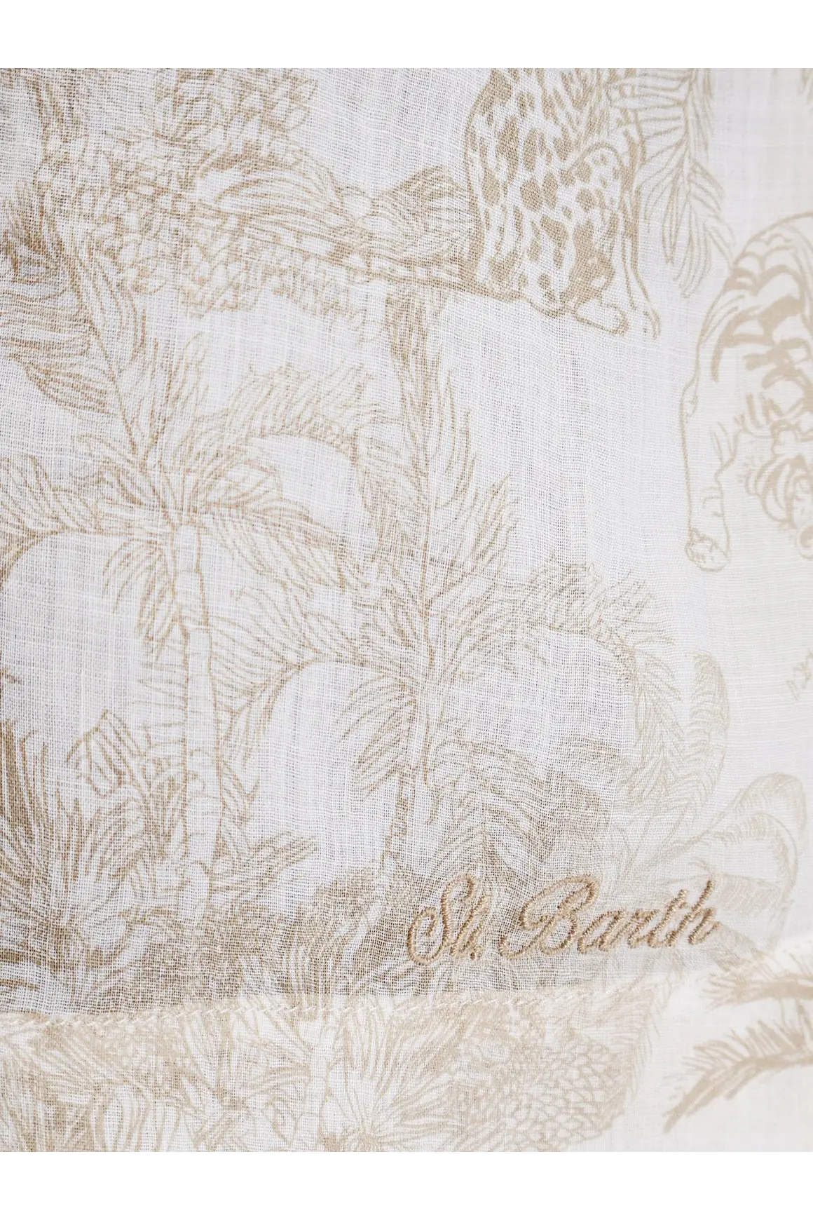 A delicate off-white ramie scarf with a subtle beige jungle print featuring palm trees and embroidered st for women