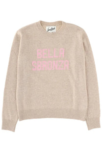 Beige knit sweater with pink bella sbronza lettering on the chest from mc2 saint barth women’s new queen jersey collection