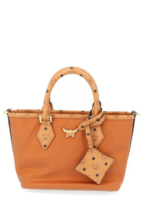 Tan mcm women’s aren mini shopper tote bag in beige with signature monogram pattern and gold tone hardware
