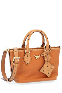 Tan mcm tote bag with signature logo pattern and gold-tone hardware in beige for women mini shopper use