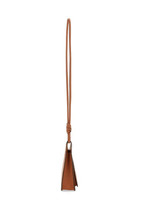 Tan leather shoulder bag by Mcm featuring a knotted strap and triangular flap closure in himmel brown