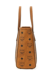 Tan leather mcm women’s tote bag in beige with embossed logo and diamond pattern for stylish everyday use