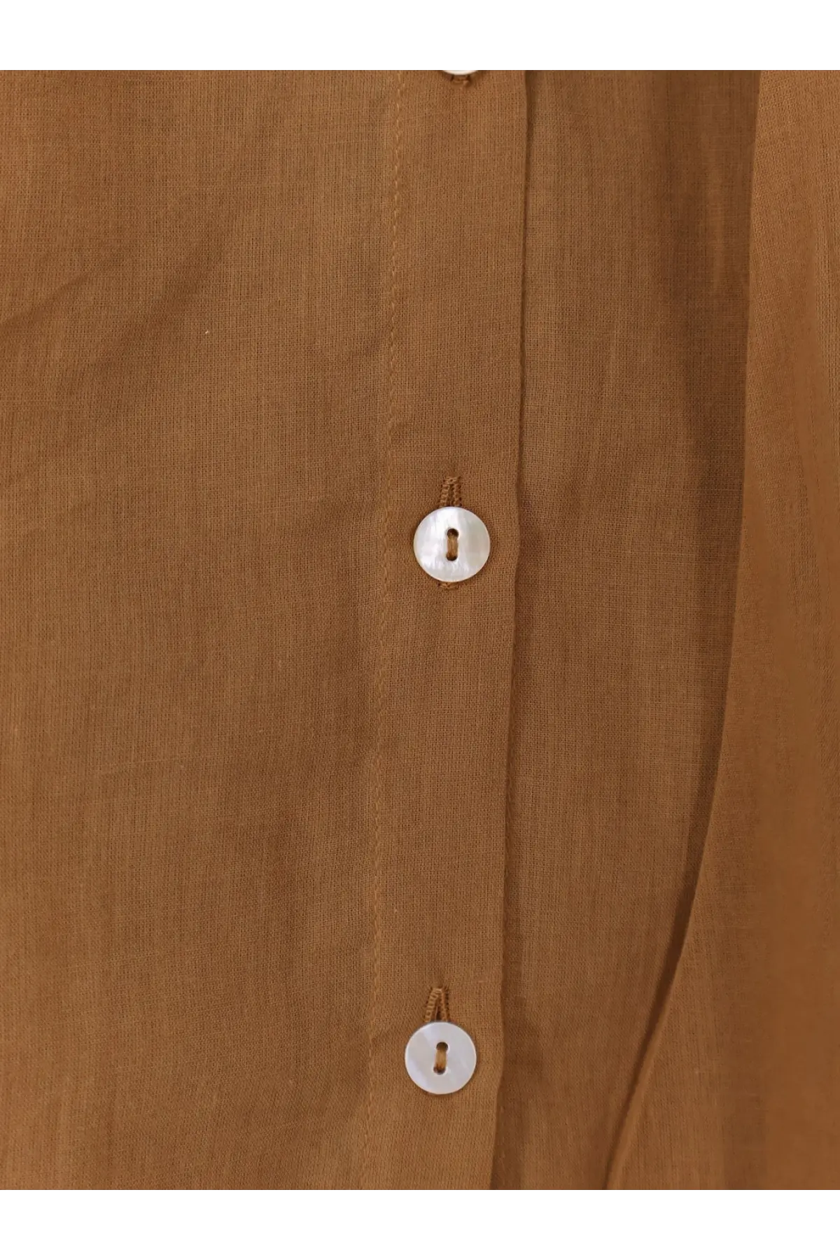 A close-up of mes demoiselles women’s celeste beige cotton shirt with three white buttons on the front placket