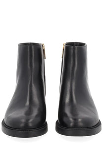 Michael Kors women’s Mandy black leather ankle boots with gold-tone zippers front view