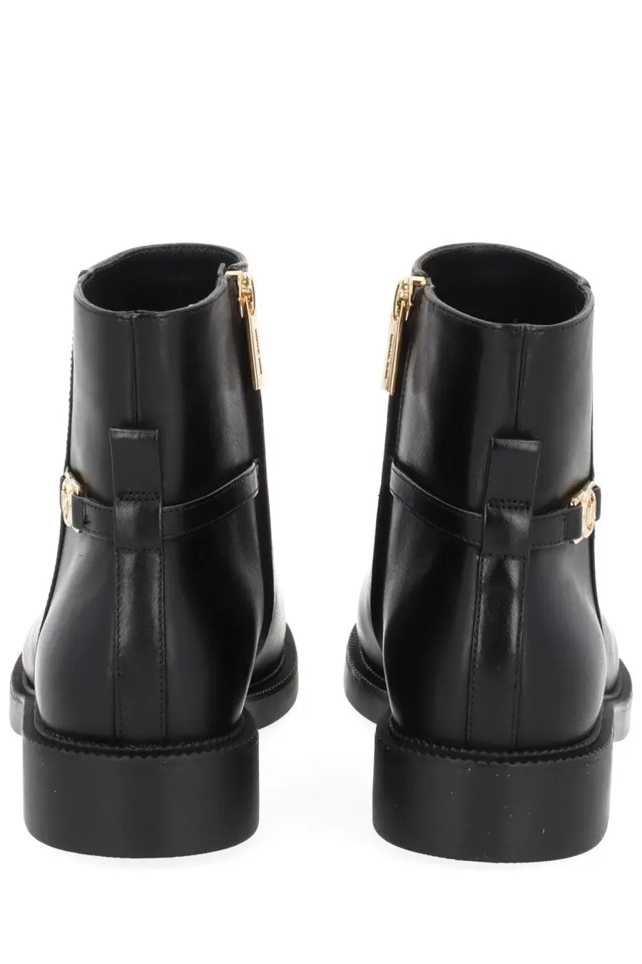 Black patent leather ankle boots by Michael Kors with gold-tone zippers and buckle details for women
