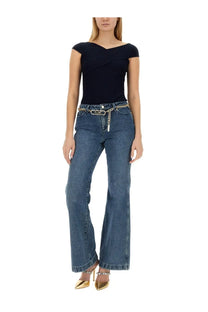 Michael Kors women’s blue denim flare fit jeans with gold chain belt detail front view